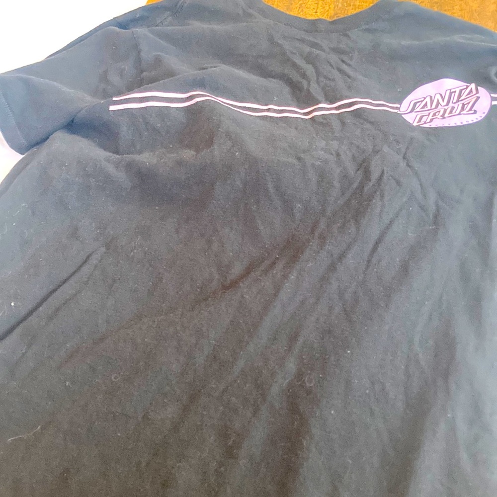Black shirt with purple Sana cruise logo on front and back.